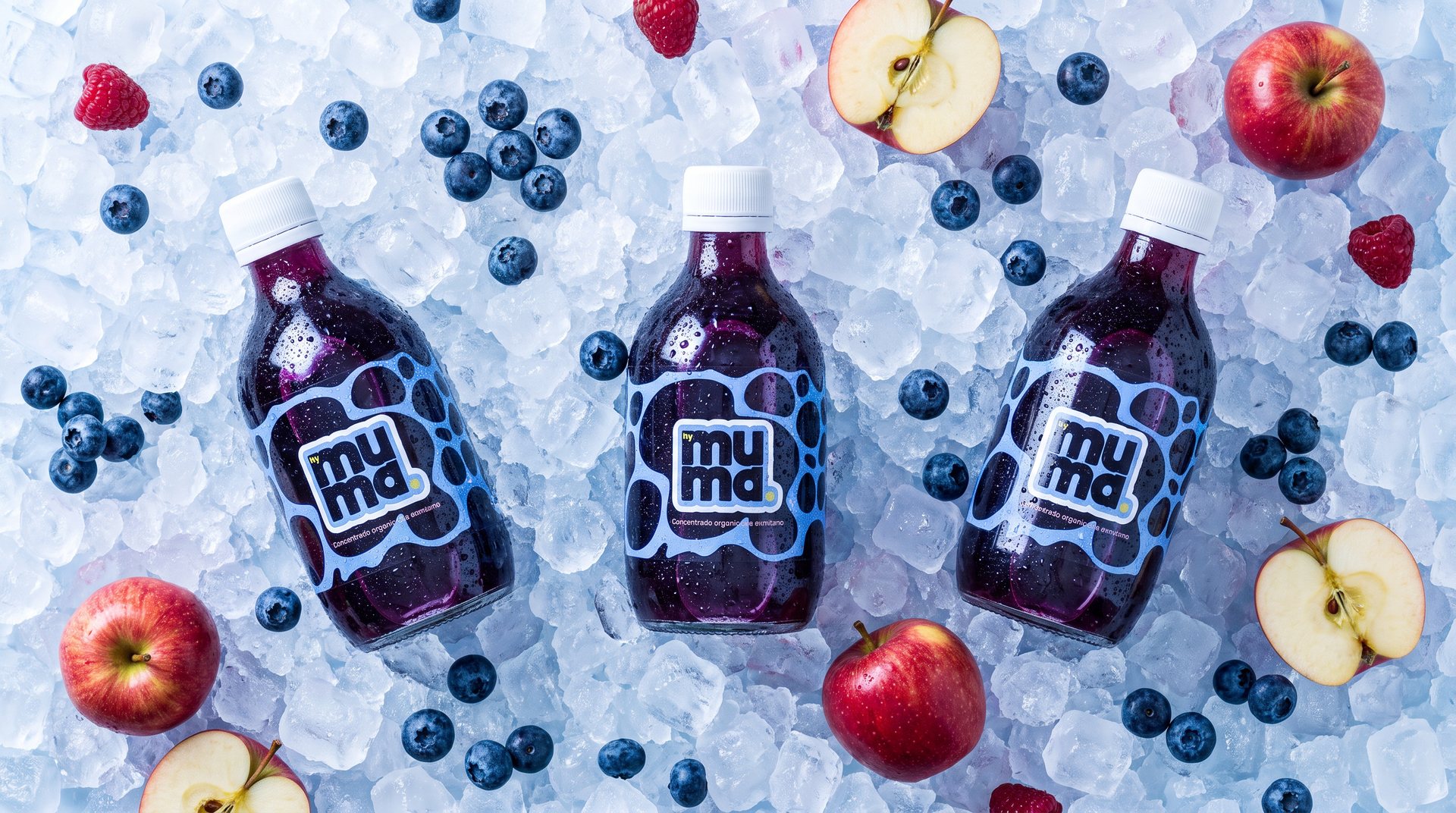 Botellas de muma sobre hielo con arándanos
